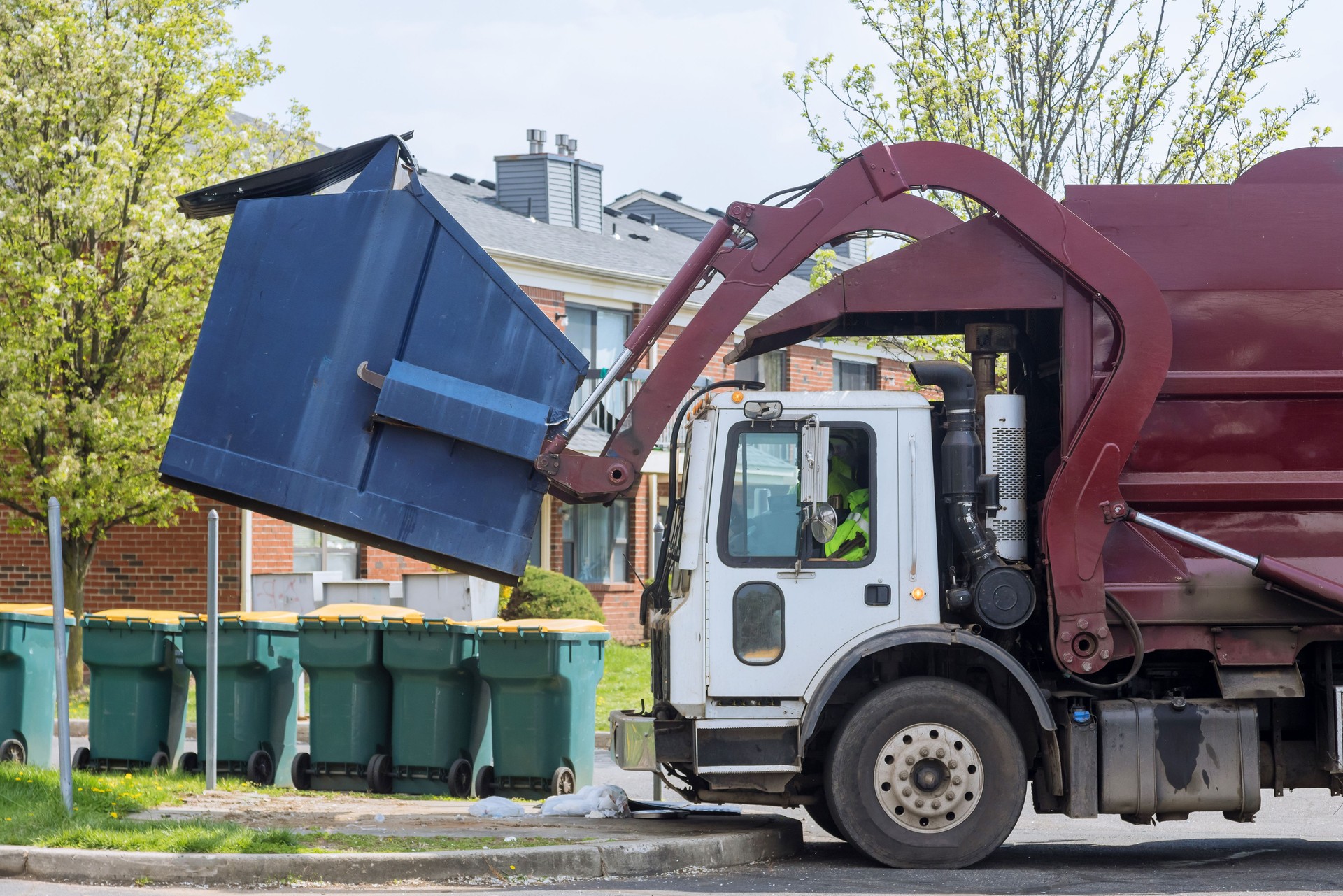 Red truck with a loading household container home maintenance public services